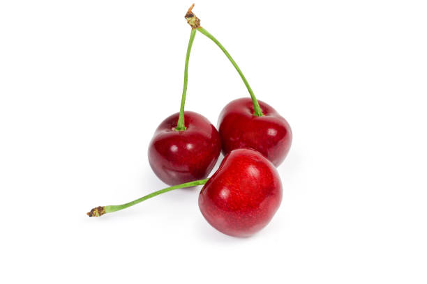 istock Three red sweet cherries with stalks on white background 1163499472