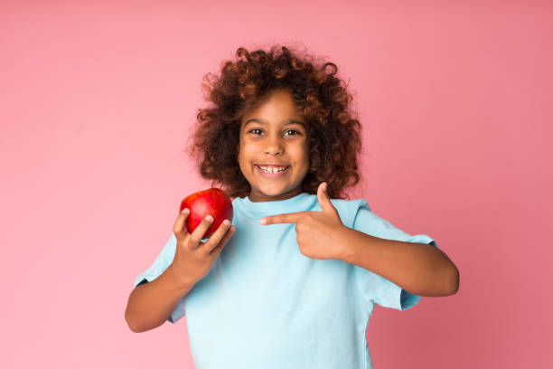 istock Healthy eating. Happy girl pointing on apple 1163501033