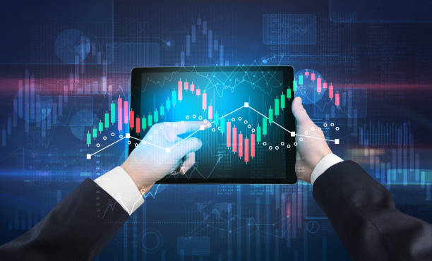 istock Hand holding tablet with global reports and stock market change concept 1163501635