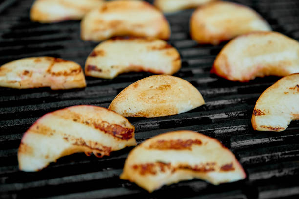 istock Grilled peach on black gas grill. Grilled dessert. 1163501956
