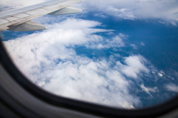 istock Looking majestic sea of clouds through airplane window 1163502028
