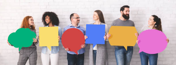 istock Group of millennials holding blank colorful speech bubbles 1163502172