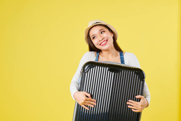 istock Female traveler hugging suitcase 1163503354