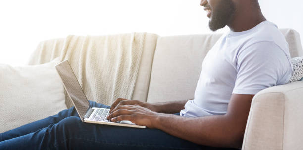 istock African american guy playing video game on laptop 1163503628