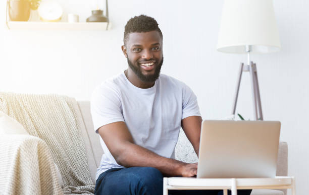 istock Millennial black man working on laptop in home office 1163503648