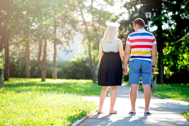 istock Future parents couple at sunset in park 1163503784