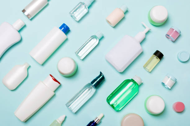 istock Top view of different cosmetic bottles and container for cosmetics on blue background. Flat lay composition with copy space 1163504200