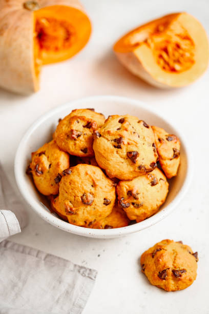 istock Pumpkin cookies with chocolate chips made from cake mix in a white ceramic bowl. 1163504832
