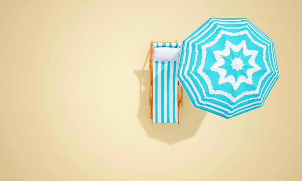 istock lounger with an umbrella on sand color top view 1163504894