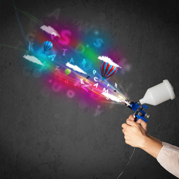 Worker with airbrush and colorful abstract clouds and balloons