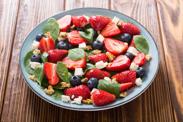 istock Summer Strawberry salad with spinach , cheese , nuts and blueberry 1163507667