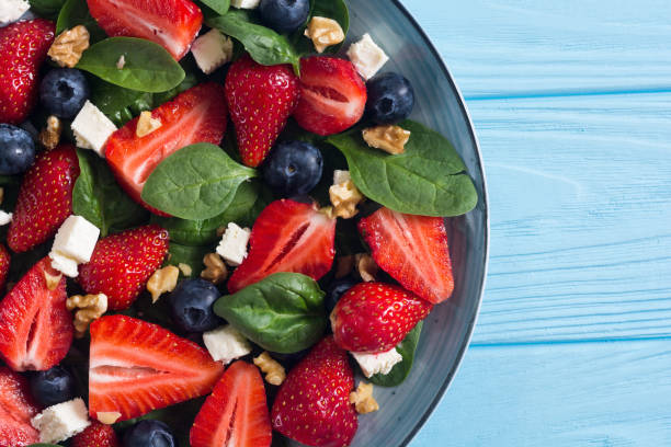 istock Summer Strawberry salad with spinach , cheese , nuts and blueberry 1163507695