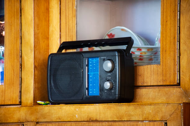 Retro vintage transistor radio of Indian and tibetan people in living room of house stock photo
