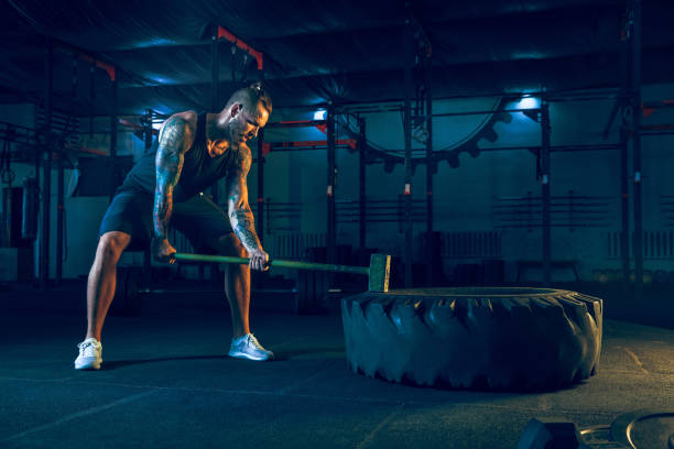 istock Young healthy man athlete doing exercise in the gym 1163508661