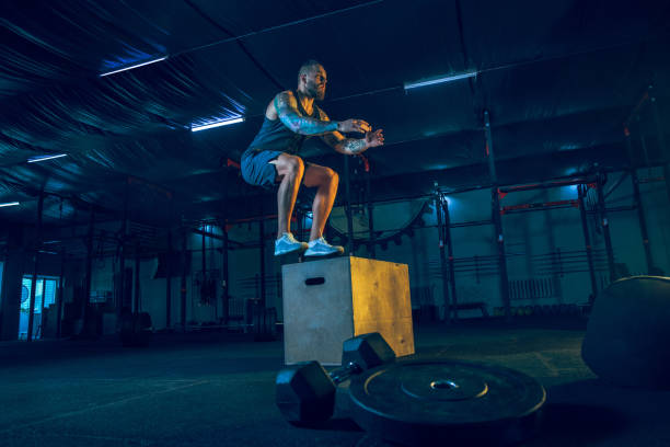 istock Young healthy man athlete doing exercise in the gym 1163508667