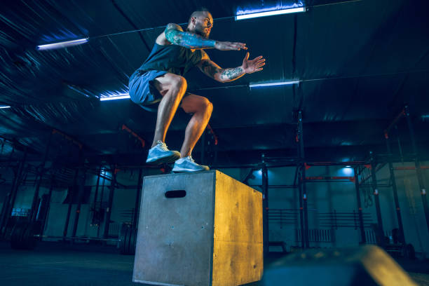 istock Young healthy man athlete doing exercise in the gym 1163508682