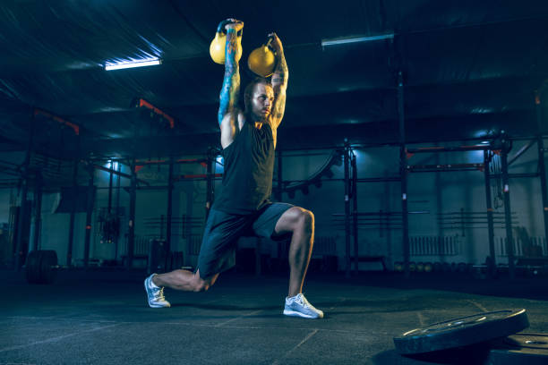 istock Young healthy man athlete doing exercise in the gym 1163508701