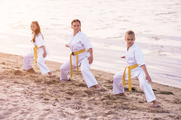 istock Group of karate children is training on the sand 1163508973