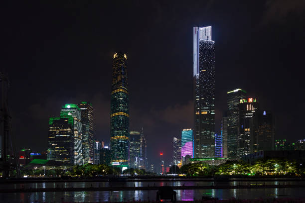 Central business district in Guangzhou Guangzhou, China - August 16 2018: Illuminated skyscrapers of the Central business district refflecting in the Pearl River. Guangzhou CTF Finance Centre