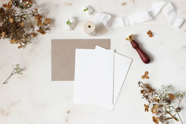 istock Winter, fall wedding, birthday table composition. Stationery mockup scene. Greeting cards, envelope, dry hydrangea flowers, wax seal stamp and ribbon on marble table backgound. Flat lay, top view. 1163519318
