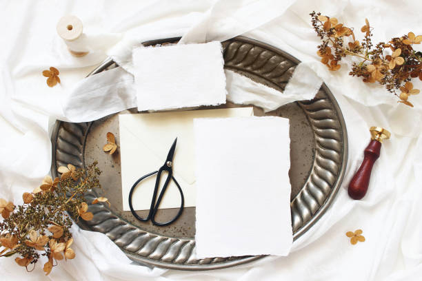 istock Winter, fall wedding, birthday table composition. Stationery mockup scene. Greeting cards, envelope, dry hydrangea flowers and silk ribbon on old vintage tray. White silk fabric background. 1163519387