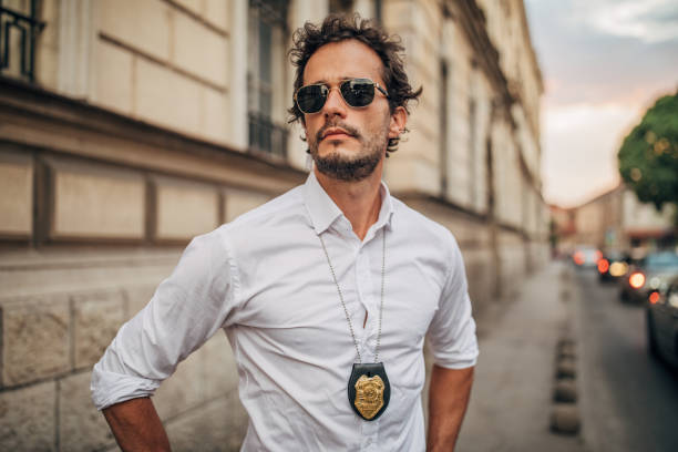 istock Handsome detective standing on the street alone 1163519656