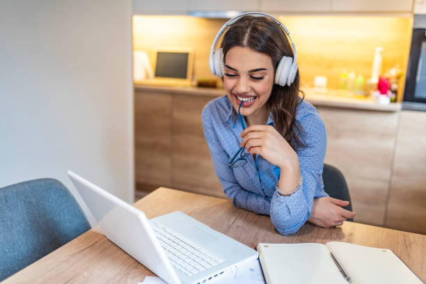 istock Woman watching video lecture on line sitting at home. 1163520875