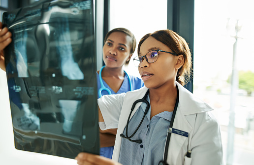 Shot of two medical practitioners analysing x-rays in a hospital