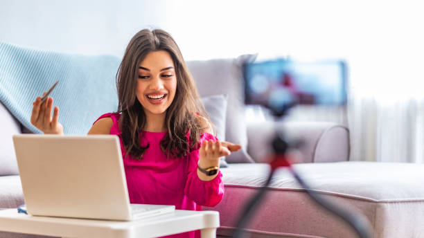 istock Young woman looking at camera while working on laptop 1163522291