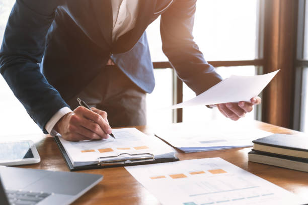 istock business people working in modern office calculating financial in company, problem and solution concept. 1163522659