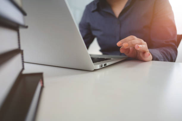 istock close up woman using laptop in cafe. 1163522693