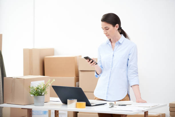 istock Contemporary female manager using smartphone and laptop for taking orders 1163522760