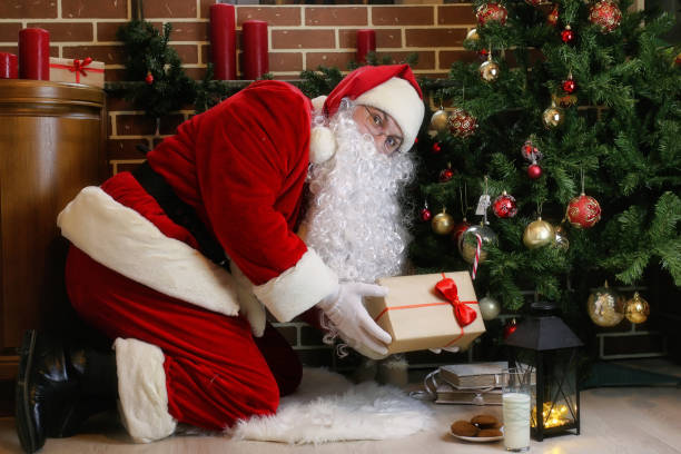 istock Santa Claus with gifts Christmas tree 1163523503