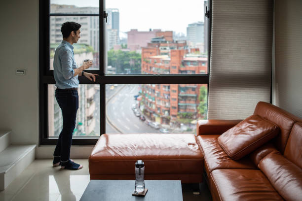 istock Enjoying first coffee and stunning view from his apartment 1163526504