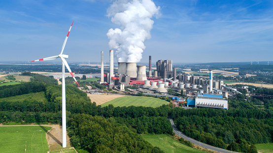 Wind turbine and coal power station - fuel and power generation in the past and nowadays. Aerial view