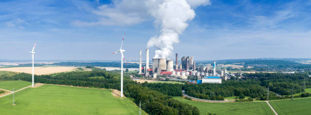 istock Wind turbine and coal power station 1163528500