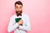 Photo of interested wearing eyeglasses specs weird loony mad of reading hipster having hobby holding green book cover in hands isolated pastel background