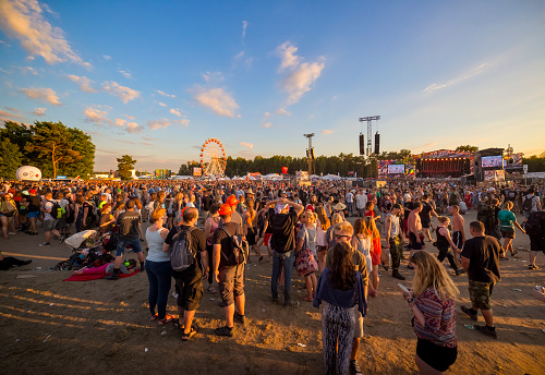 Kostrzyn Nad Odra, Poland - August 04, 2017:Tens of thousands of young people are having fun during afternoon concert on main stage at 23th Woodstock Festival - the biggest open air ticket free rock music festival in Europe