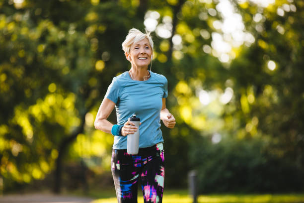 istock Senior woman jogging in the park 1163530276