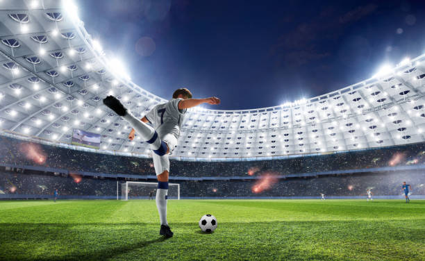 Soccer Soccer players in action on professional stadium in evening. stadium playing field grass fifa world cup stock pictures, royalty-free photos & images
