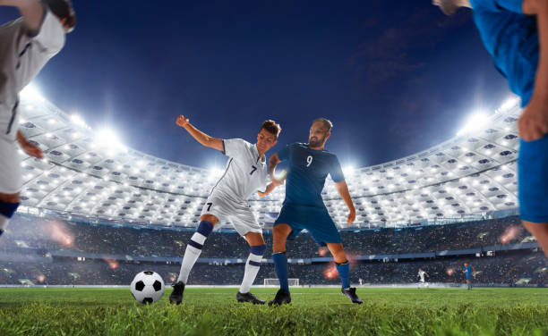 Soccer Soccer players in action on professional stadium in evening. stadium playing field grass fifa world cup stock pictures, royalty-free photos & images