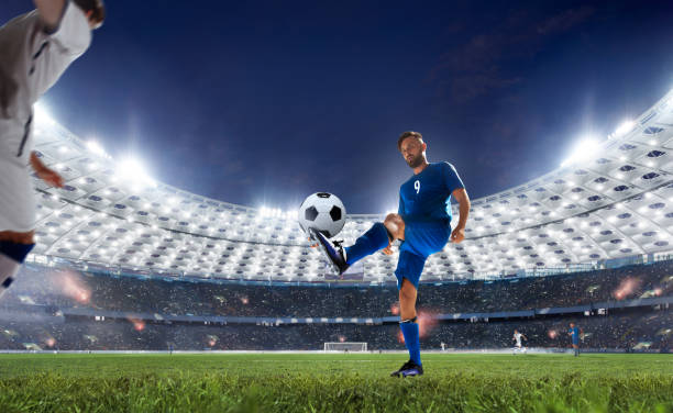 Soccer Soccer players in action on professional stadium in evening. stadium playing field grass fifa world cup stock pictures, royalty-free photos & images