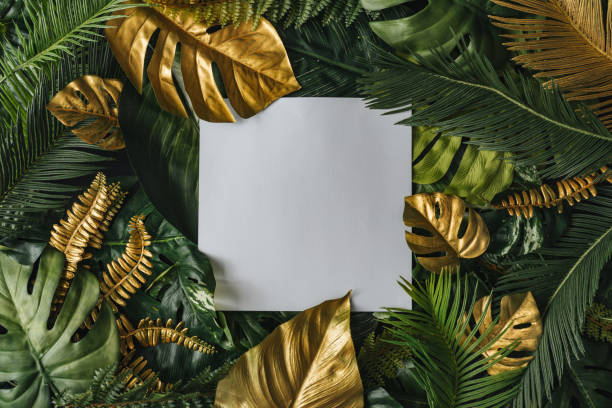istock Creative nature background. Gold and green tropical palm leaves. 1163535202