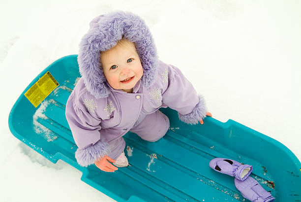 Purple Sledding Baby stock photo