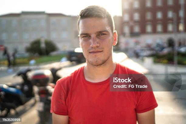 Portrait Of A Serene Young Man Stock Photo - Download Image Now - Serious, Young Men, Red