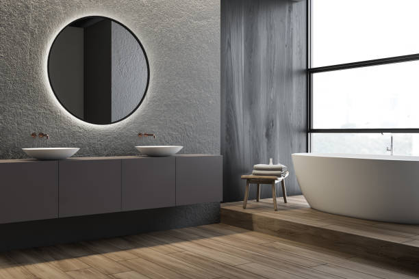 istock Concrete bathroom corner, double sink and tub 1163536063