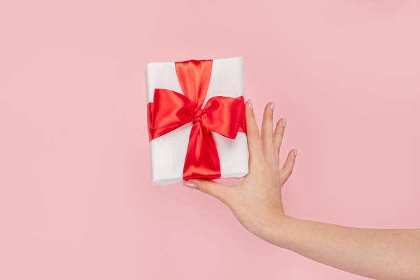 istock Girl with small wrapped gift box 1163537615