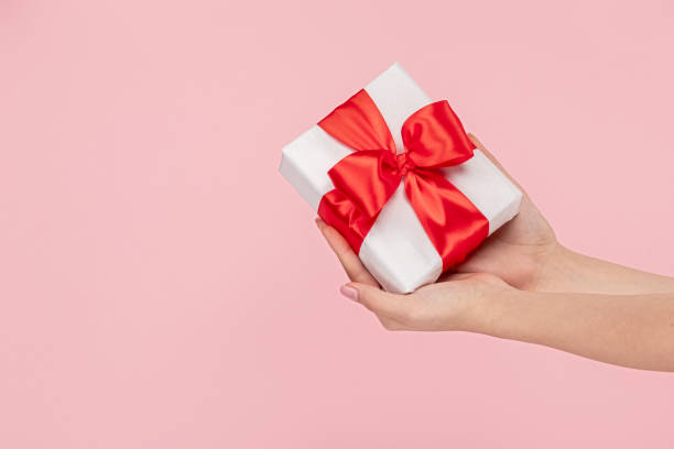 istock Crop girl showing wrapped present 1163537618