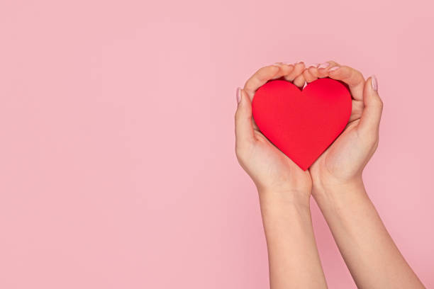 istock Woman holding red paper heart 1163537627