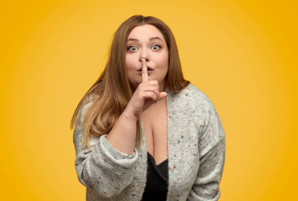 istock Plump woman making silence gesture 1163538660